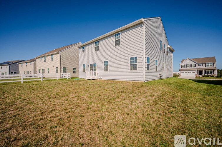 A large white building with a fence in front of it.