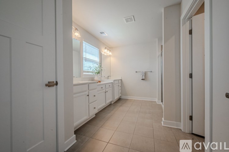 A kitchen with white cabinets and a tiled floor.