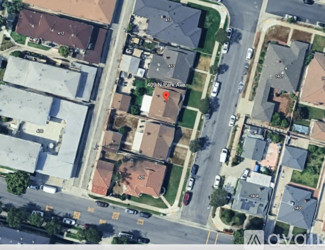 A street view of a residential area with houses numbered 409 to 412.