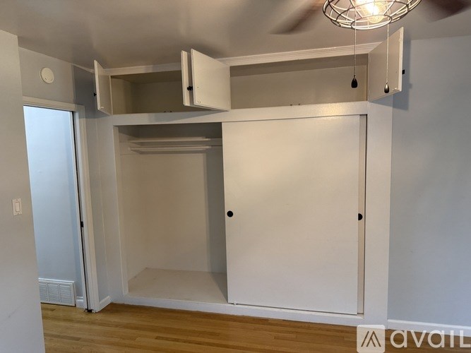 A room with a white cabinet and a light fixture.