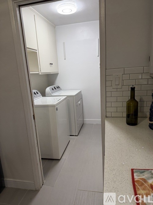 A small kitchen with a white fridge and a white washing machine.