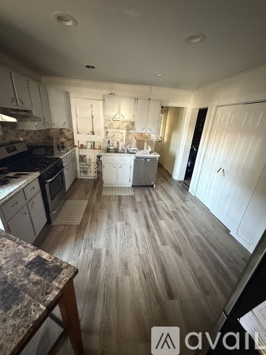 A kitchen with a dishwasher and a stove top oven.