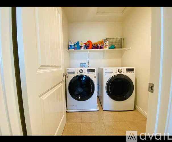 Two washing machines in a small laundry room.