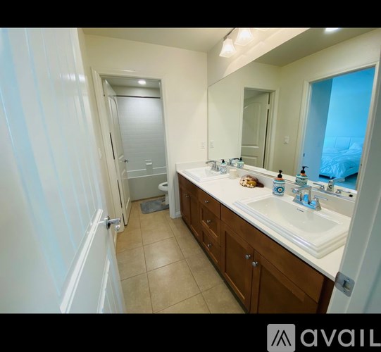 A bathroom with a sink, mirror, and toiletries.