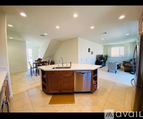 A kitchen with a sink and a refrigerator.