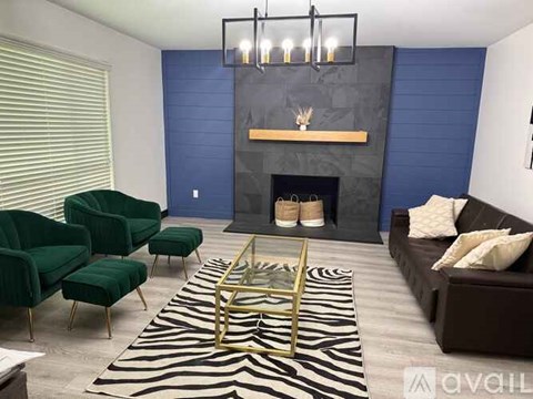 A living room with a zebra rug and a fireplace.