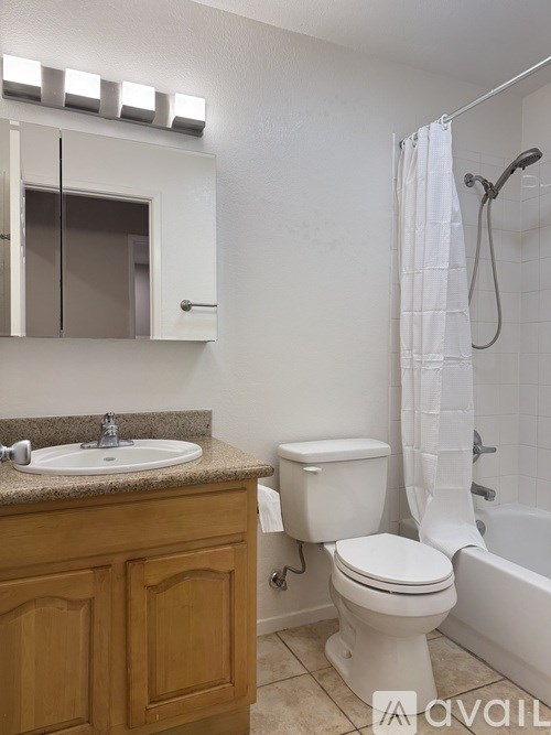 A bathroom with a toilet, sink, and shower.