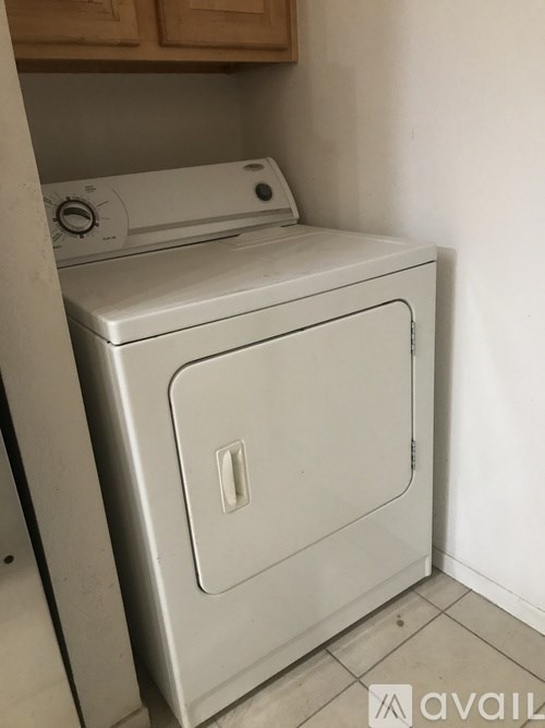 A white dishwasher is sitting in a kitchen.