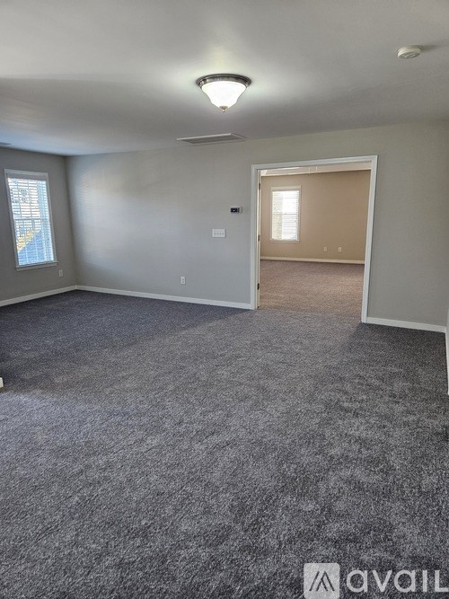 A room with grey carpet and a white ceiling.