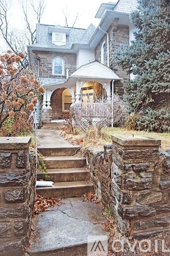 A house with a stone staircase leading to a porch.