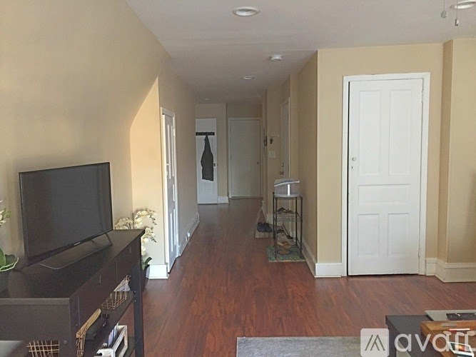 A living room with a television and a door.