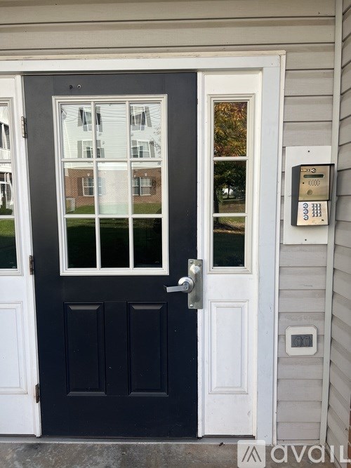 A black door with a glass window and a silver handle.