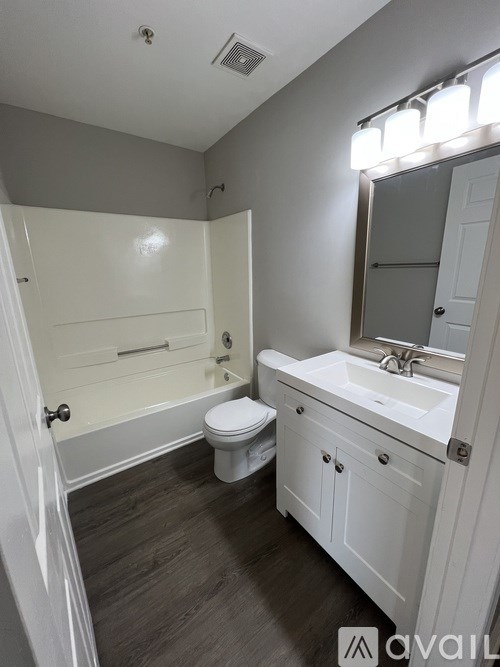 A bathroom with a toilet, sink, and bathtub.