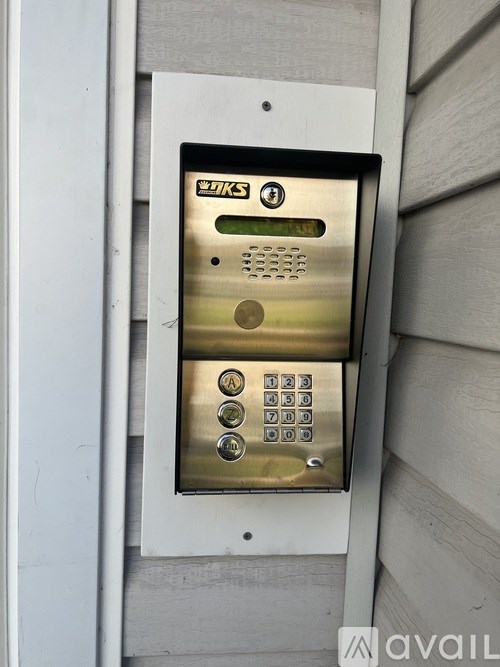 A keypad with the letters A, B, C, and D is mounted on a wall.