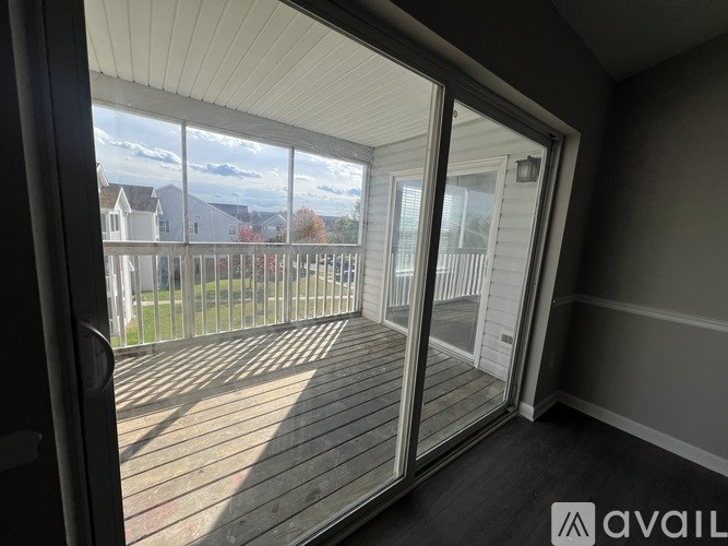 A balcony with a view of houses and trees.