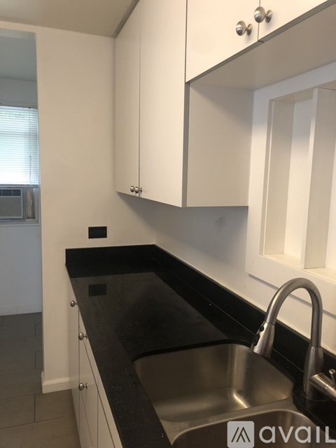 A kitchen with a sink and cabinets.