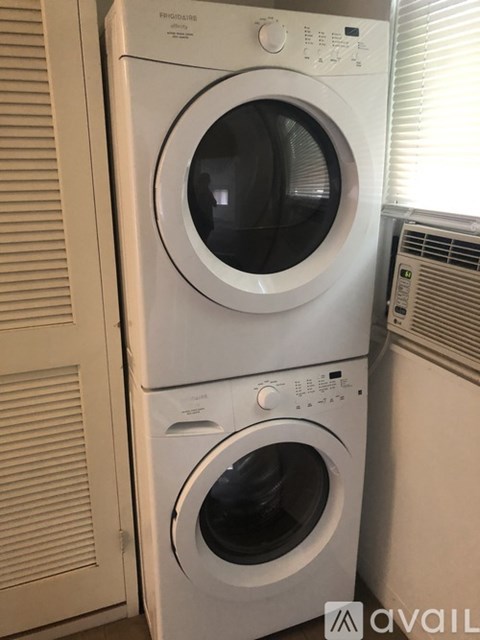 A stack of two front loading washing machines.