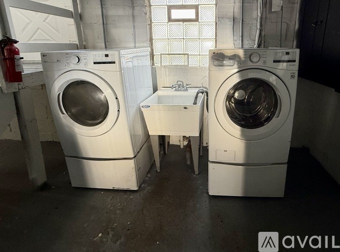 Two front loading washing machines in a laundry room.