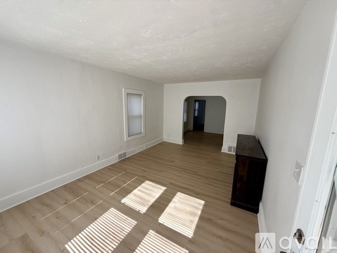A room with wooden flooring and a white ceiling.