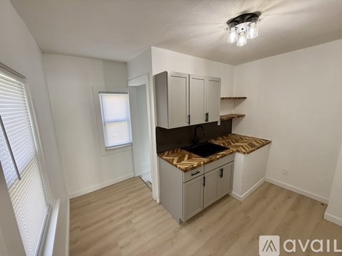 A kitchen area with a countertop and cabinets.