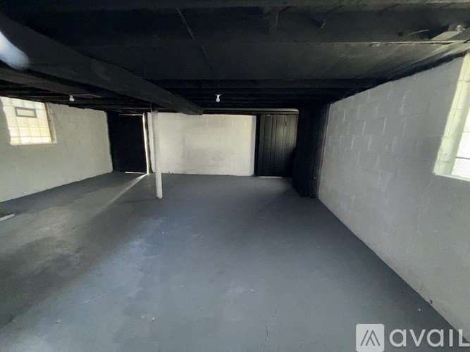 A spacious, empty room with a concrete floor and walls.