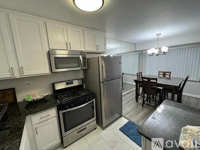 A kitchen with a stove, oven, microwave, and refrigerator.