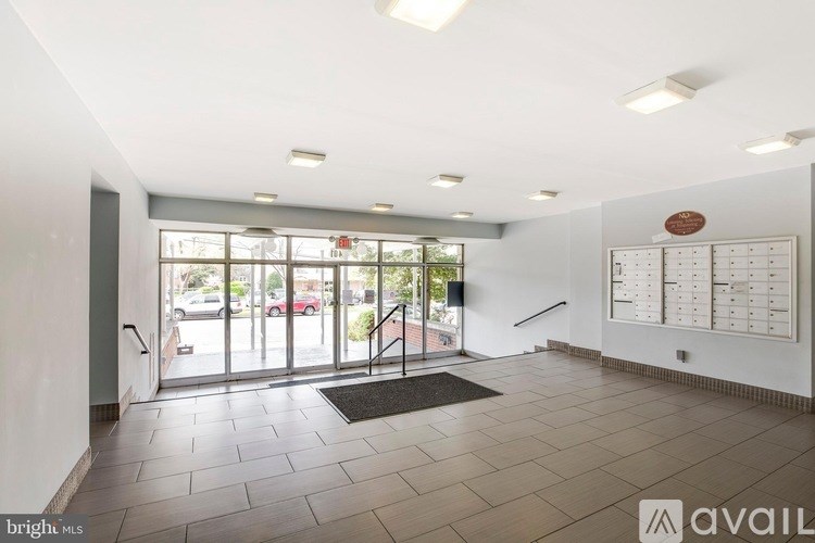 A brightly lit office lobby with a calendar on the wall and a door leading outside.