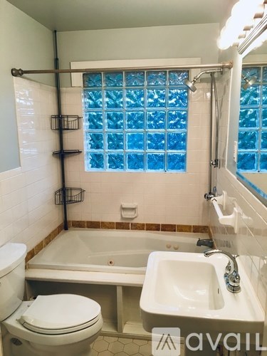 A bathroom with a toilet, sink, and bathtub.