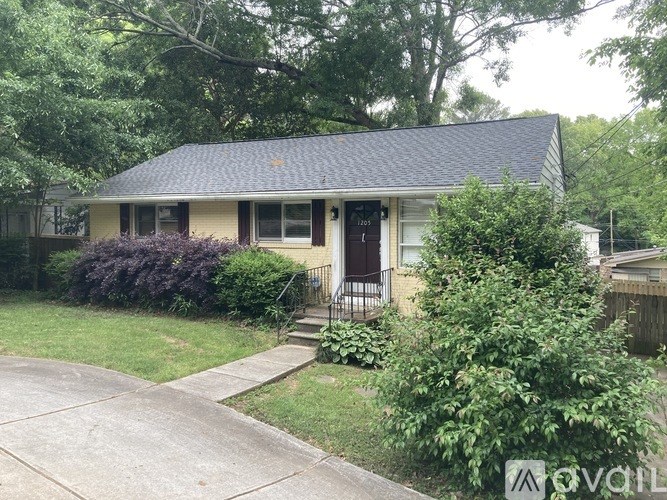 A house with a front yard and a driveway.