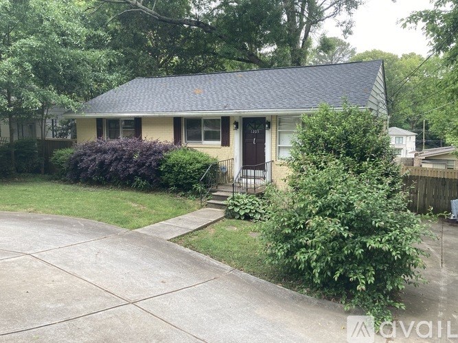 A house with a blue roof and a brown door.