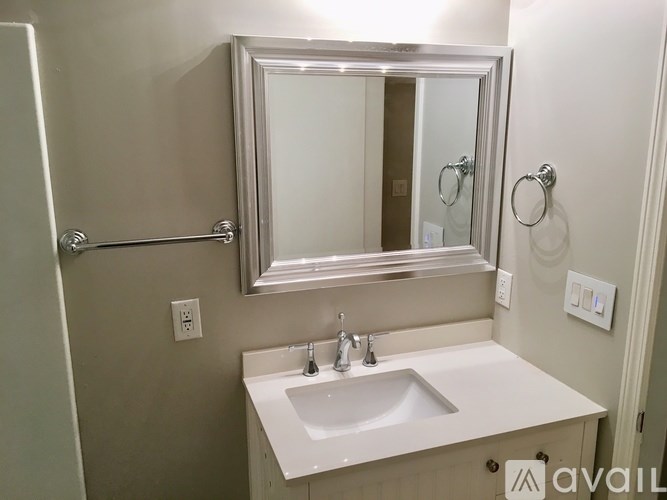 A bathroom with a sink and mirror.