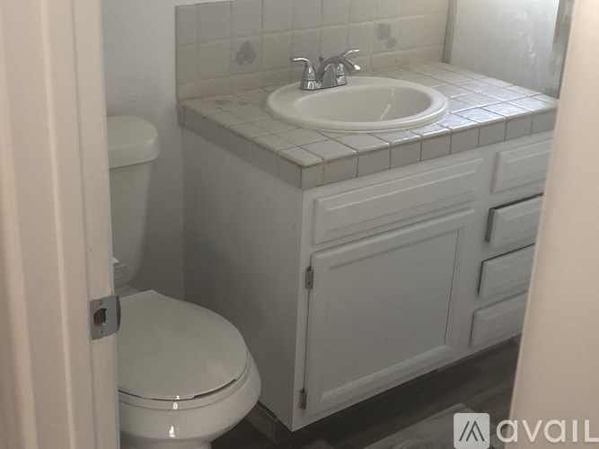 A white toilet is next to a sink in a small bathroom.