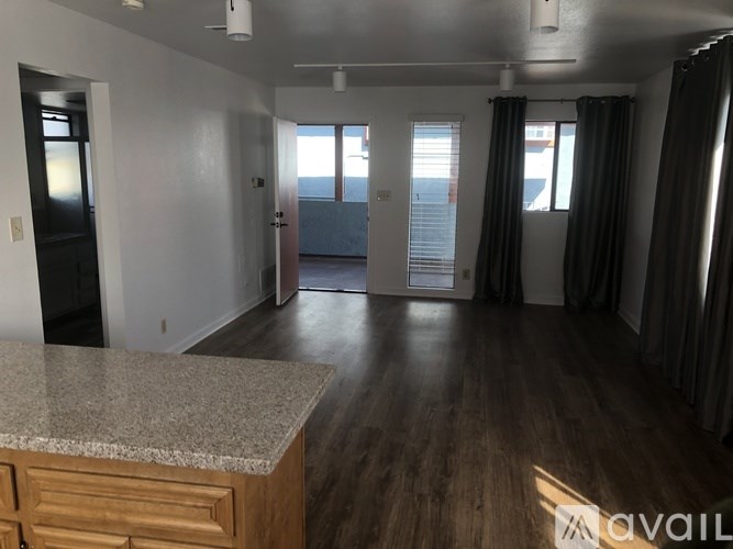A room with a marble countertop and wooden floors is available for rent.