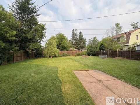 A backyard with a baseball diamond and a fence.
