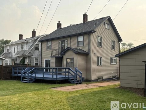 A house with a deck in front of it.