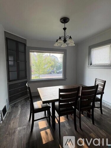 A dining room with a table set for four.