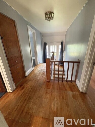 A room with wooden floors and a wooden door.
