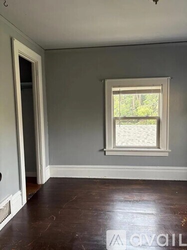 A room with a window and a door.