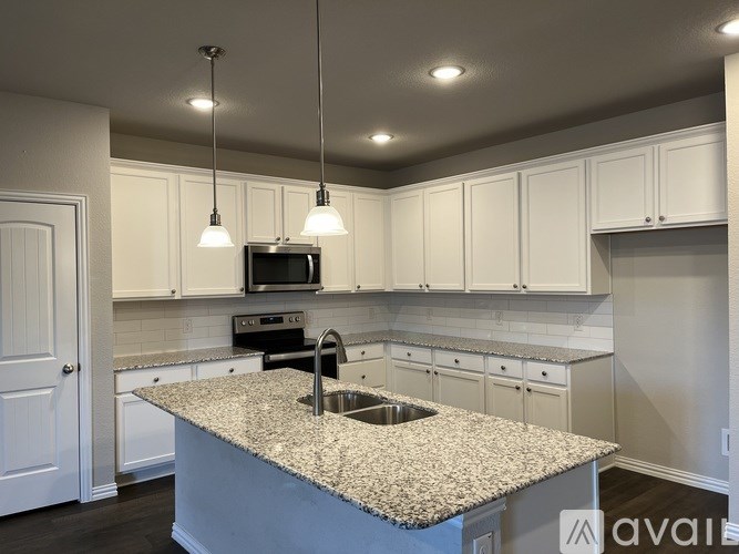 A house with a garage door and a driveway.