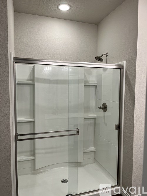 A glass shower door in a bathroom.