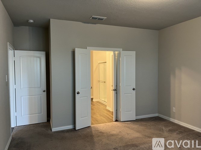 A room with three doors, one of which is open.