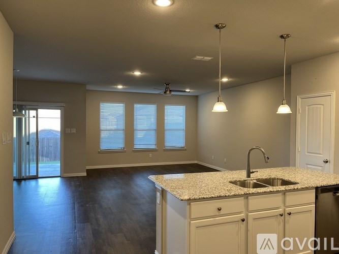 A kitchen with a granite countertop and a sink.