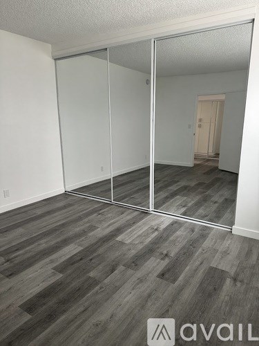 A room with a sliding door and wood flooring.