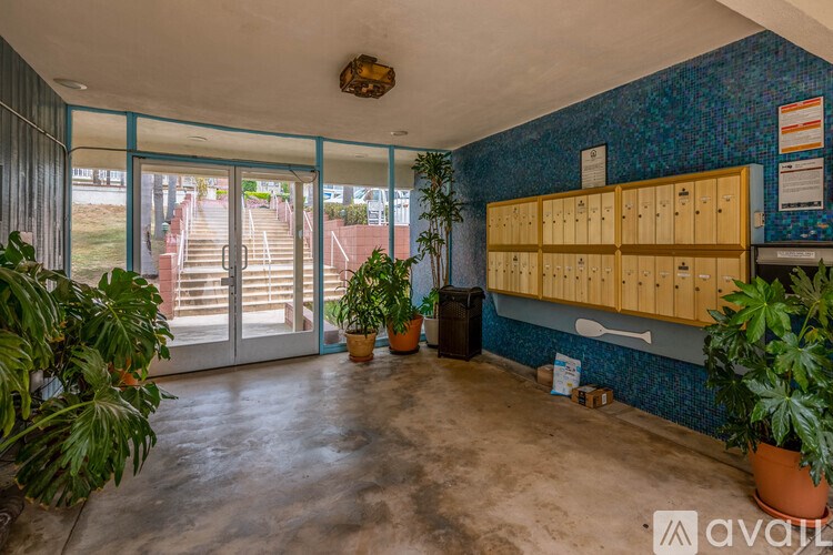 A room with a blue wall and a wooden cabinet.