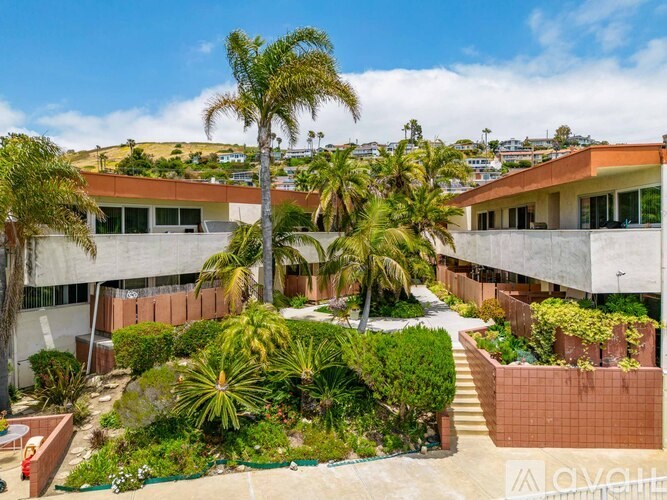 A modern house with a garden in front.