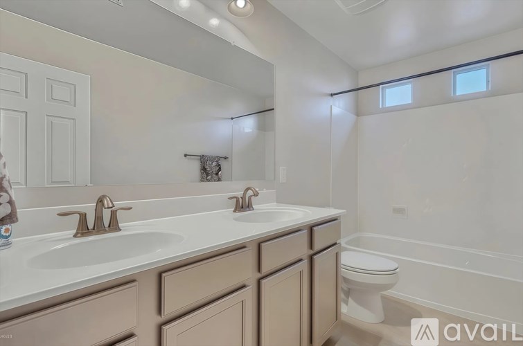 A bathroom with a white countertop and a toilet.