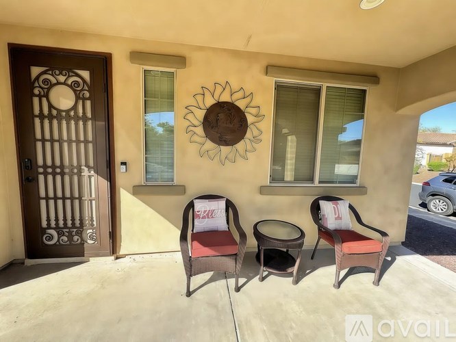 A patio with two chairs and a table is available for rent.