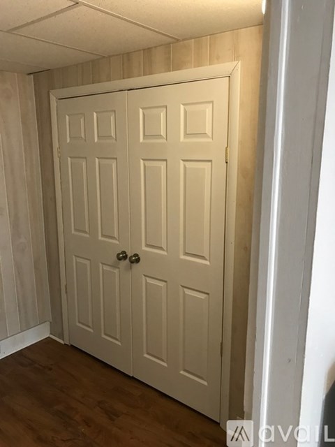 A white door with a handle and a lock.