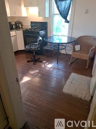 A kitchen with a table and chairs.