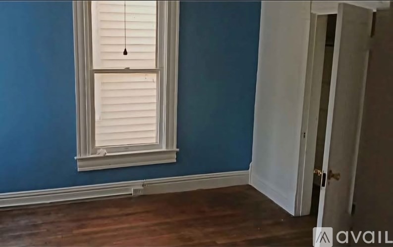 A room with a window and a door.